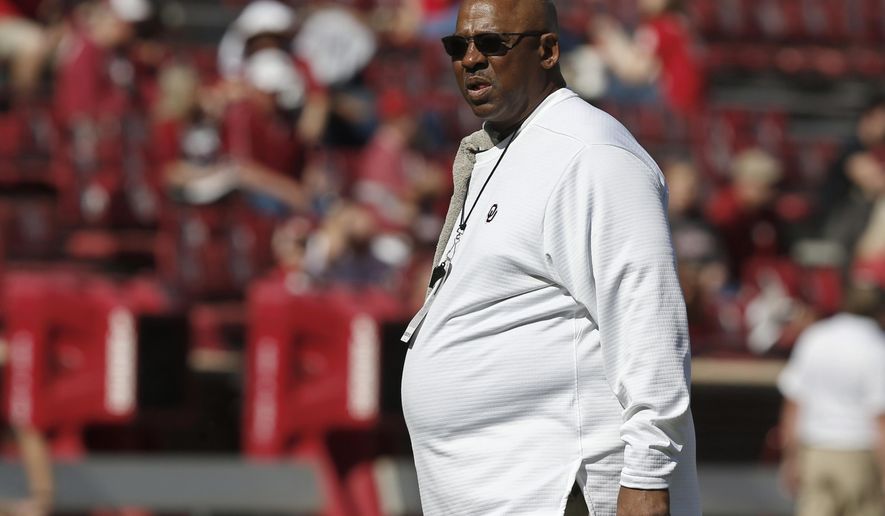 FILE - In this Oct. 27, 2018, file photo, Oklahoma defensive coordinator Ruffin McNeill watches players before an NCAA college football game between Kansas State and Oklahoma in Norman, Okla. The Sooners played so poorly in a 48-45 regular-season loss to Texas that they fired defensive coordinator Mike Stoops. The numbers actually got worse under McNeill, but the past two games offered glimmers of hope. (AP Photo/Sue Ogrocki, File)
