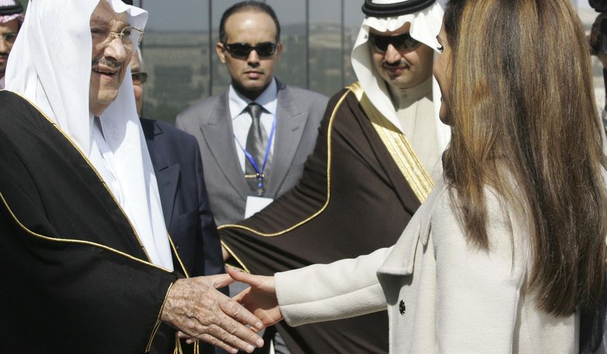 FILE - In this Feb. 24, 2010 file photo, Saudi Prince Talal bin Abdelaziz, left, receives Queen Rania of Jordan during the opening ceremony of the Arab Open University, Jordan branch, in Amman, Jordan. Abdulaziz, a senior member of the royal family who supported women's rights and once led a group of dissident princes, has died at the age of 87. Prince Talal was an older brother to King Salman and the father of businessman Prince Alwaleed bin Talal. The royal court said prayers for Prince Talal, who died on Saturday, will be held in Riyadh on Sunday, Dec. 23, 2018. (AP Photo/Nader Daoud, File)