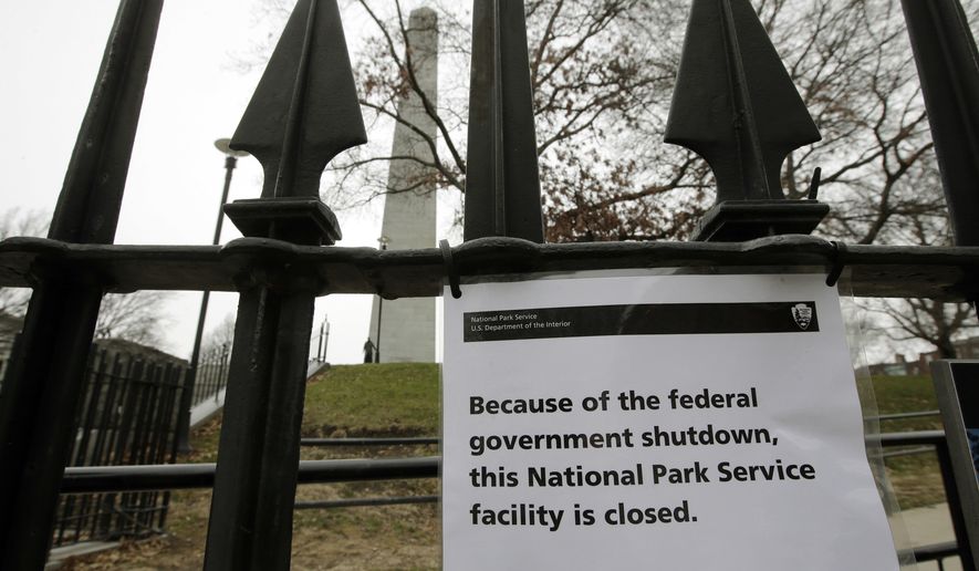 A sign is posted on a fence near an entrance to the Bunker Hill Monument, Monday, Dec. 24, 2018, in Boston. The historic site, erected to commemorate the Revolutionary War Battle of Bunker Hill, and run by the National Park Service, was closed Monday due to a partial federal government shutdown. The federal government is expected to remain partially closed past Christmas Day in a protracted standoff over President Donald Trump&#x27;s demand for money to build a border wall with Mexico. (AP Photo/Steven Senne)