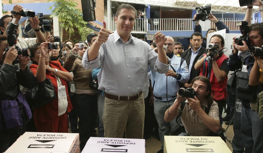 FILE - In this July 4, 2010 file photo, Rafael Moreno Valle, candidate of the "Compromiso por Puebla" party coalition, flashes two thumbs up after casting his vote during state elections in Puebla, Mexico. Moreno Valle, who went on to win the 2010 gubernatorial race, died in what local media are reporting as a helicopter crash on Christmas Eve, Monday, Dec. 24, 2018, along with his wife Martha Erika Alonso, who is currently the governor of Puebla. (AP Photo/Joel Merino, File)