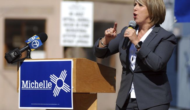 FILE - In this Oct. 25, 2018 photo, New Mexico gubernatorial candidate and U.S. Rep. Michelle Lujan Grisham speaks to an audience including many unionized state workers in Santa Fe, N.M. (AP Photo/Morgan Lee)