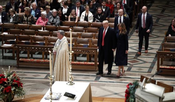 President Donald Trump and first lady Melania Trump arrive for a Christmas Eve service at the National Cathedral, Monday, Dec. 24, 2018, in Washington. (AP Photo/Jacquelyn Martin)