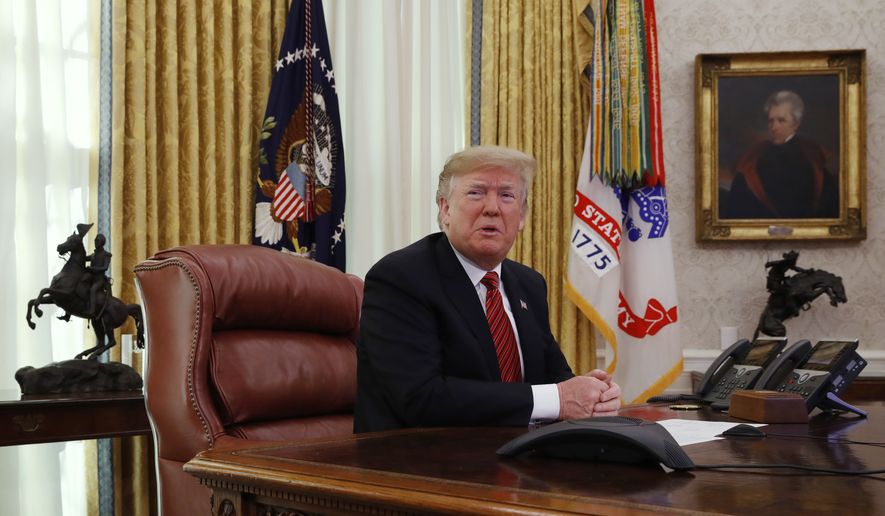 President Donald Trump answers questions from the media after speaking with members of the military by video conference on Christmas Day, Tuesday, Dec. 25, 2018, in the Oval Office of the White House. (AP Photo/Jacquelyn Martin)
