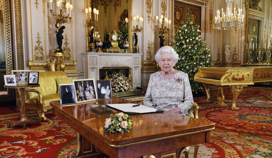 In this image released on Tuesday, Dec. 25, 2018, Britain's Queen Elizabeth poses for a photograph after she recorded her annual Christmas Day message, in the White Drawing Room of Buckingham Palace, London. (John Stillwell/Pool via AP)