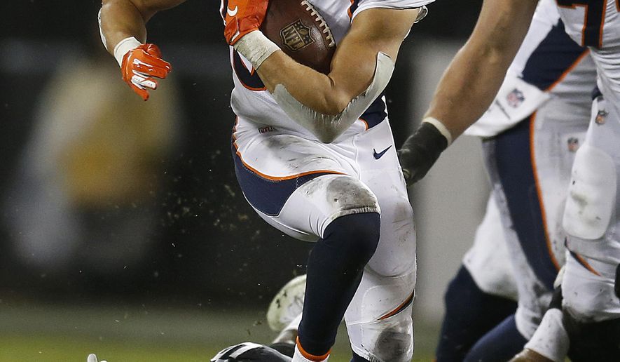 Denver Broncos running back Phillip Lindsay runs against the Oakland Raiders during the first half of an NFL football game in Oakland, Calif., Monday, Dec. 24, 2018. (AP Photo/D. Ross Cameron)