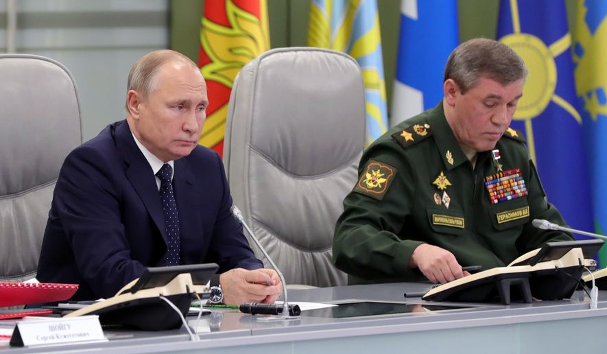 Russian President Vladimir Putin, left, and Chief of General Staff of Russia Valery Gerasimov oversee the test launch of the Avangard hypersonic glide vehicle from the Defense Ministry&#x27;s control room in Moscow, Russia, Wednesday, Dec. 26, 2018. In the test, the Avangard was launched from the Dombarovskiy missile base in the southern Ural Mountains. The Kremlin says it successfully hit a designated practice target on the Kura shooting range on Kamchatka, 6,000 kilometers (3,700 miles) away. (Mikhail Klimentyev, Sputnik, Kremlin Pool Photo via AP)