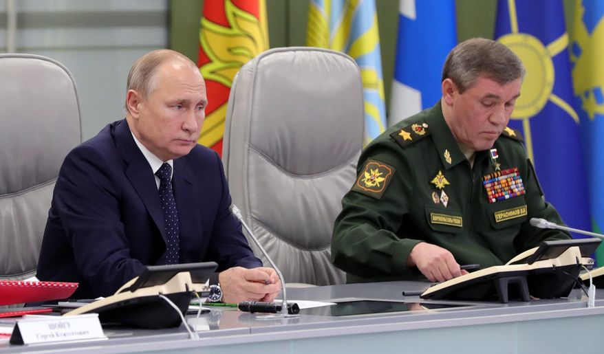Russian President Vladimir Putin, left, and Chief of General Staff of Russia Valery Gerasimov oversee the test launch of the Avangard hypersonic glide vehicle from the Defense Ministry&#x27;s control room in Moscow, Russia, Wednesday, Dec. 26, 2018. In the test, the Avangard was launched from the Dombarovskiy missile base in the southern Ural Mountains. The Kremlin says it successfully hit a designated practice target on the Kura shooting range on Kamchatka, 6,000 kilometers (3,700 miles) away. (Mikhail Klimentyev, Sputnik, Kremlin Pool Photo via AP)