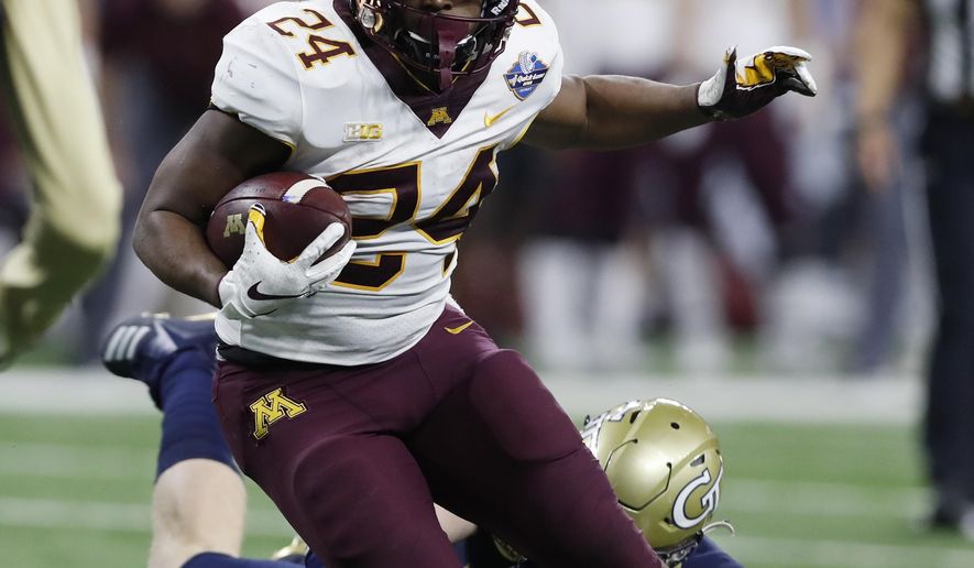 Minnesota running back Mohamed Ibrahim (24) carries during the first half of the Quick Lane Bowl NCAA college football game against Georgia Tech, Wednesday, Dec. 26, 2018, in Detroit. (AP Photo/Carlos Osorio)