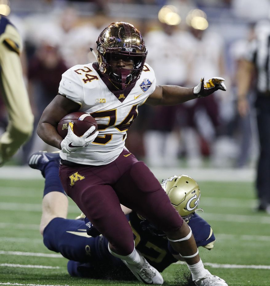 Minnesota running back Mohamed Ibrahim (24) carries during the first half of the Quick Lane Bowl NCAA college football game against Georgia Tech, Wednesday, Dec. 26, 2018, in Detroit. (AP Photo/Carlos Osorio)
