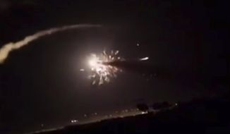 This frame grab from a video provided by the Syrian official news agency SANA shows missiles flying into the sky near Damascus, Syria, Tuesday, Dec. 25, 2018. Israeli warplanes flying over Lebanon fired missiles toward areas near the Syrian capital of Damascus late Tuesday, hitting an arms depot and wounding three soldiers, Syrian state media reported, saying that most of the missiles were shot down by air defense units. (SANA via AP)