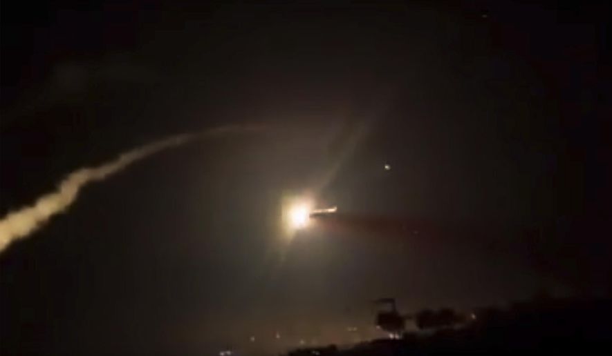 This frame grab from a video provided by the Syrian official news agency SANA shows missiles flying into the sky near Damascus, Syria, Tuesday, Dec. 25, 2018. Israeli warplanes flying over Lebanon fired missiles toward areas near the Syrian capital of Damascus late Tuesday, hitting an arms depot and wounding three soldiers, Syrian state media reported, saying that most of the missiles were shot down by air defense units. (SANA via AP)