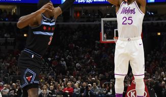 Minnesota Timberwolves guard Derrick Rose (25) shoots over Chicago Bulls guard Kris Dunn during the first half of an NBA basketball game Wednesday, Dec. 26, 2018, in Chicago. (AP Photo/Matt Marton)