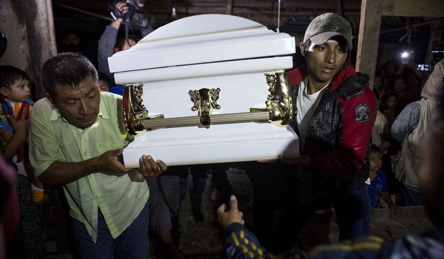 Neighbors carry the coffin that contain the remains of 7-year-old Jakelin Caal Maquin into her grandparent&#x27;s home in San Antonio Secortez, Guatemala, Monday, Dec. 24, 2018. The body of a 7-year-old girl who died while in the custody of the U.S. Border Patrol was handed over to family members in her native Guatemala on Monday for a last goodbye. (AP Photo/ Oliver de Ros)