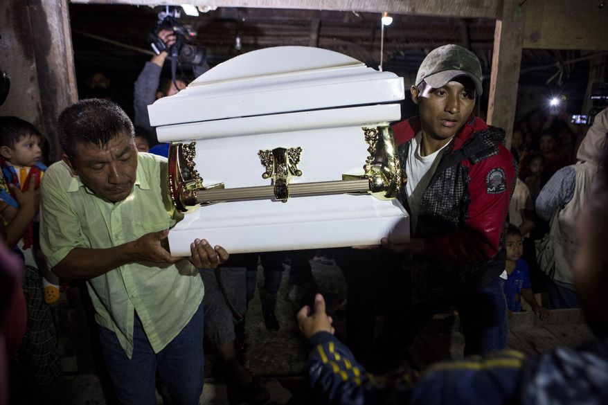 Neighbors carry the coffin that contain the remains of 7-year-old Jakelin Caal Maquin into her grandparent&#39;s home in San Antonio Secortez, Guatemala, Monday, Dec. 24, 2018. The body of a 7-year-old girl who died while in the custody of the U.S. Border Patrol was handed over to family members in her native Guatemala on Monday for a last goodbye. (AP Photo/ Oliver de Ros)