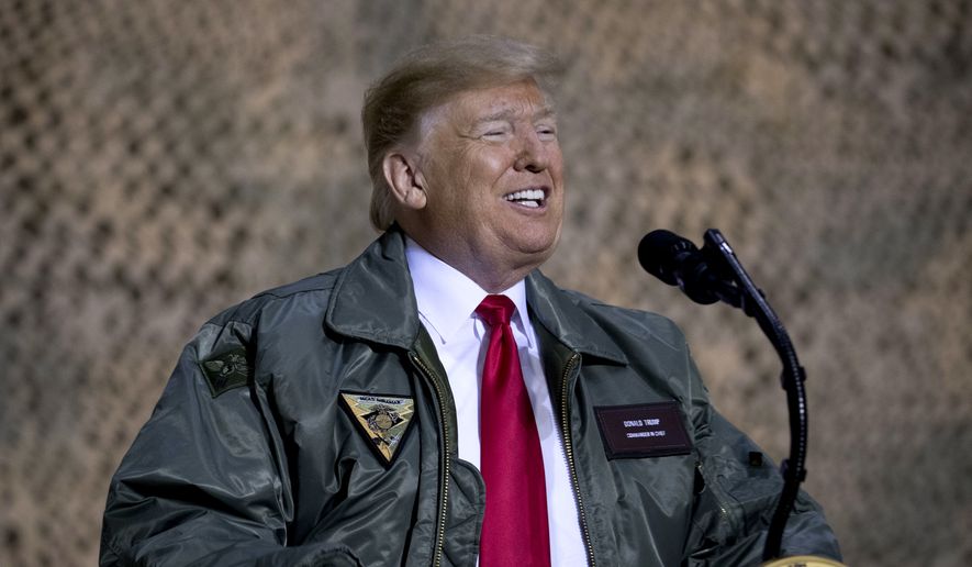 President Donald Trump speaks at a hangar rally at Al Asad Air Base, Iraq, in this Wednesday, Dec. 26, 2018, file photo. (AP Photo/Andrew Harnik) ** FILE **