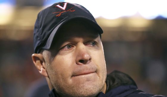 This Nov. 4, 2017, file photo shows Virginia head coach Bronco Mendenhall reacting after a win over Georgia Tech in an NCAA college football game in Charlottesville, Va. Mendenhall said the extra practices have been critical to the development of the team&#39;s up-and-coming players as he tries to build the program, but for seniors like safety Juan Thornhill, who will be playing his final game, much more is at stake in the year the leaders have hyped a `new standard&#39; for Virginia.  (AP Photo/Zack Wajsgras, File) **FILE**