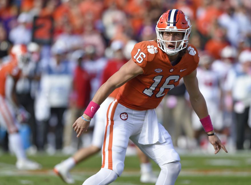 FILE - In this Oct. 20, 2018, file photo, Clemson quarterback Trevor Lawrence calls a play during the first half of the team's NCAA college football game against North Carolina State in Clemson, S.C. Clemson and Notre Dame weren’t even a month into this season when both made unexpected quarterback switches. The Tigers and Fighting Irish were undefeated with senior quarterbacks who had won a lot of games, and neither of those starters was even injured. Still, the coaches for both teams decided to make a change then--and are still without a loss going for a national title. After playing behind Kelly Bryant in each of Clemson’s first four games, Lawrence was named the starter before the Sept. 29 game at Wake Forest. (AP Photo/Richard Shiro, File)