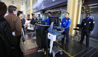 Transportation Security Administration (TSA) officers check and watch airline passengers at Reagan National Airport in Washington, Thursday, Dec. 27, 2018. (AP Photo/Manuel Balce Ceneta)