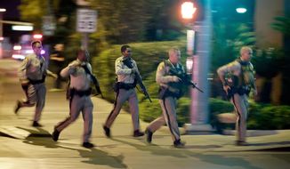 FILE - In this Oct. 1, 2017, file photo, police run toward the scene of a shooting near the Mandalay Bay resort and casino on the Las Vegas Strip in Las Vegas. In documents made public Thursday, Dec. 27, 2018, police in Las Vegas have released transcripts of some officers&#39; accounts about what they saw, heard and did trying to locate and stop a gunman who unleashed the deadliest mass shooting in the nation&#39;s modern history almost 15 months earlier. (AP Photo/John Locher, File)