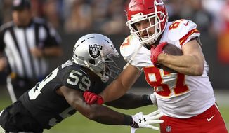 File-This Dec. 2, 2018, file photo shows Kansas City Chiefs tight end Travis Kelce (87) running against Oakland Raiders linebacker Tahir Whitehead (59) during the second half of an NFL football game in Oakland, Calif.  The Chiefs could have taken this week off, assured of not only their third consecutive AFC West title but also the No. 1 seed in the playoffs before the Oakland Raiders came to town. Instead, they’ll have everything on the line Sunday. (AP Photo/Ben Margot, File)