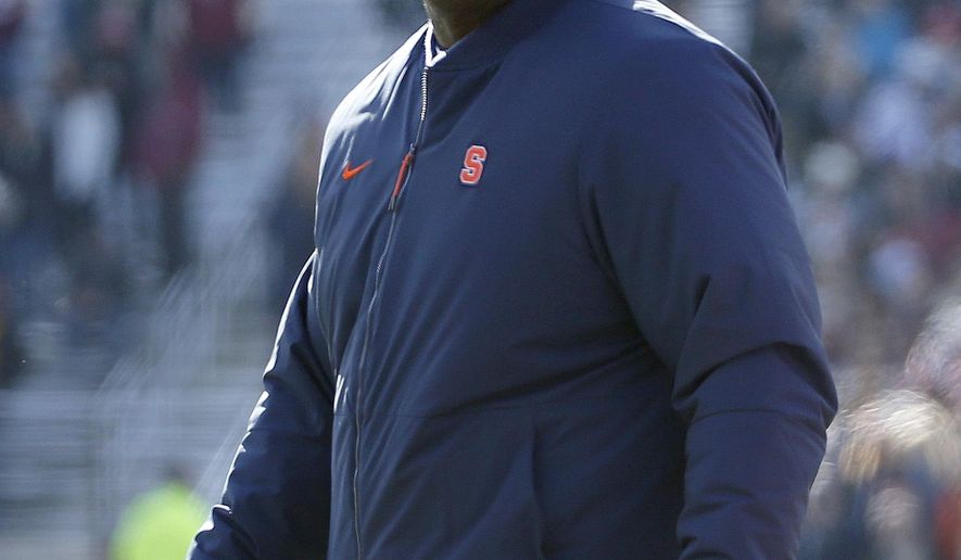 FILE- In this Nov. 24, 2018 file photo, Syracuse head coach Dino Babers looks on during the first half of an NCAA college football game against Boston College, Saturday in Boston. Babers has transformed Syracuse into a winner in three years at the helm. The Orange, who have won nine games and are ranked No. 17, meet No. 15 West Virginia on Friday, Dec. 28, 2018 in the Camping World Bowl. Babers, who just inked a contract extension, feels this is the start of sustained success that could lead to greater heights. (AP Photo/Mary Schwalm, File)