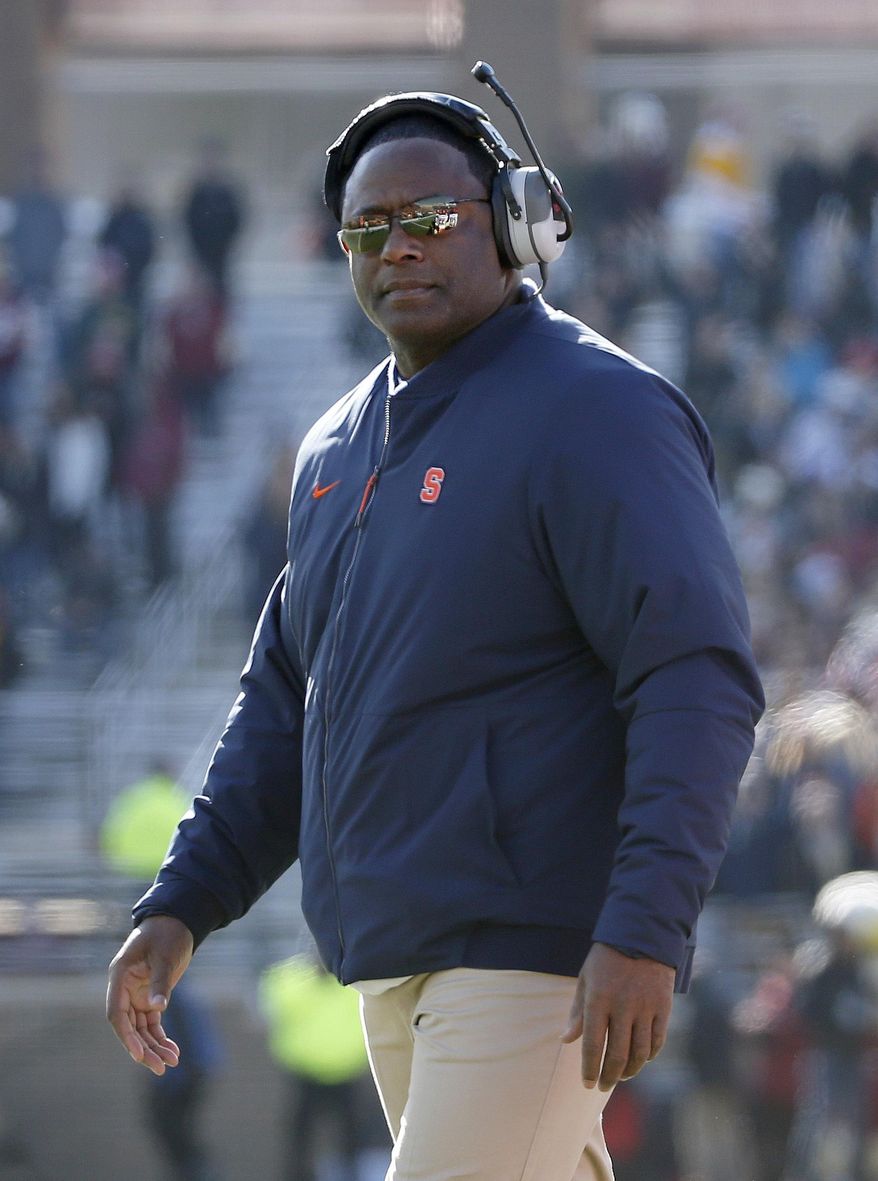 FILE- In this Nov. 24, 2018 file photo, Syracuse head coach Dino Babers looks on during the first half of an NCAA college football game against Boston College, Saturday in Boston. Babers has transformed Syracuse into a winner in three years at the helm. The Orange, who have won nine games and are ranked No. 17, meet No. 15 West Virginia on Friday, Dec. 28, 2018 in the Camping World Bowl. Babers, who just inked a contract extension, feels this is the start of sustained success that could lead to greater heights. (AP Photo/Mary Schwalm, File)