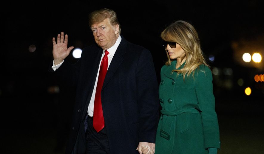 President Donald Trump and first lady Melania Trump arrive on the South Lawn of the White House after making a surprise visit to troops in Iraq, Thursday, Dec. 27, 2018, in Washington. (AP Photo/Evan Vucci)