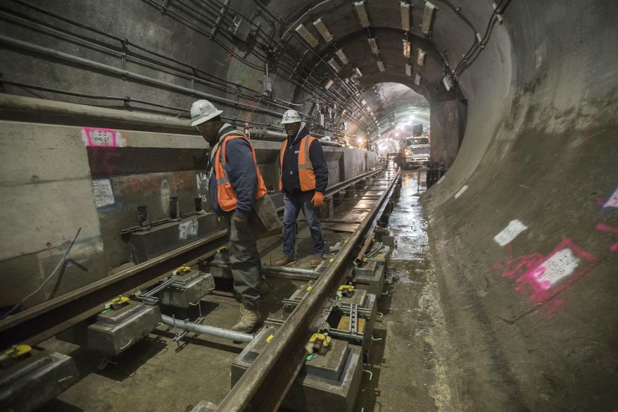 In this Nov. 29, 2018 photo, a construction crew works on the tracks of the East Side Access project beneath Grand Central Terminal in New York. The super-pricey railroad hub is taking shape, dogged by billion-dollar cost overruns and a decade of delays, but still impressive as an engineering marvel. (AP Photo/Mary Altaffer)