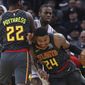 Atlanta Hawks&#39; Kent Bazemore, right, drives as Atlanta Hawks&#39; Alex Poythress, left, sets a pick on Minnesota Timberwolves&#39; Andrew Wiggins during the first half of an NBA basketball game Friday, Dec. 28, 2018, in Minneapolis. (AP Photo/Jim Mone)