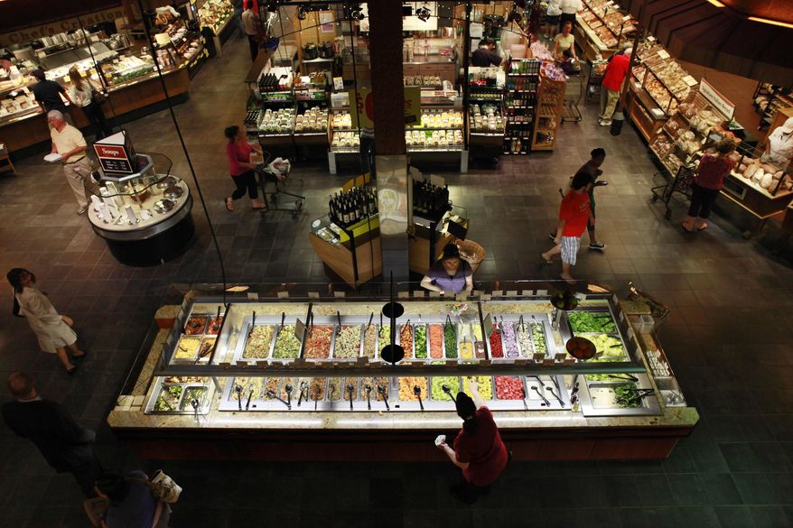 FILE - In this May 27, 2010, file photo, customers shop at the salad bar for lunch at the Market Cafe in the Wegmans grocery store in Fairfax, Va. There are shortcuts you can take at the supermarket that will help you get dinner on the table faster throughout the week. They range from choosing vegetables that are already prepped or frozen to taking home the occasional rotisserie chicken to buying bulk. (AP Photo/Jacquelyn Martin, File)