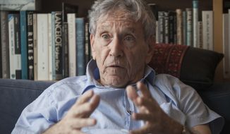 In this Nov. 4, 2015, file photo, Israeli writer Amos Oz poses for a photo at his house in Tel Aviv, Israel. Israeli media said Friday, Dec. 28, 2018 that renowned Israeli author Amos Oz has died at the age of 79. Oz, author of novels, prose and a widely acclaimed memoir, had suffered from cancer. Oz won numerous prizes, including the Israel Prize and Germany’s Goethe Award, and was a perennial contender for the Nobel Prize in literature. (AP Photo/Dan Balilty, File)