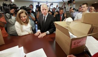 FILE - In this May 10, 2012, file photo, Gov. Jerry Brown and his wife, Anne Gust Brown, turn in boxes of petitions for his tax-hike initiative at the Sacramento County Registrar of Voters in Sacramento, Calif. In his second stint as governor, Brown warned that if voters did not pass the tax hikes there would be deeper cuts to schools, higher education and social services. Brown, who successfully convinced the legislature and voters to raise taxes on themselves, leaves office Jan. 7, 2019, after a record four terms in office, from 1975-1983 and again since 2011. (AP Photo/Rich Pedroncelli, File)