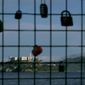 Alcatraz Island is shown behind a locks attached to a pier fence in San Francisco, Saturday, Dec. 22, 2018. A partial federal shutdown has been put in motion because of gridlock in Congress over funding for President Donald Trump&#x27;s Mexican border wall. The company that provides ferry services to Alcatraz Island kept its daytime tours but canceled behind-the-scenes and night tours. (AP Photo/Jeff Chiu)