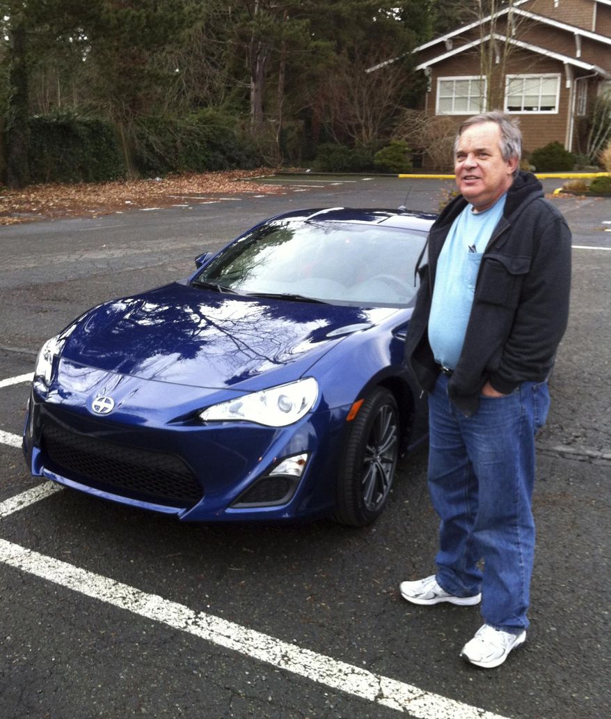 In this Dec. 14, 2013, photo provided by Shashi Karan, Alan Naiman poses with his new car, an unusual extravagance for him, in Seattle. When Naiman, a Washington state social worker, died this year of cancer at the age of 63, the generous loner left most of his surprise estate worth $11 million to children's charities helping the poor, sick, disabled, abandoned and those otherwise stuck in foster care, unbeknownst to those beneficiaries or his own loved ones. (Shashi Karan via AP)