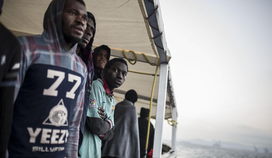 Migrants look out from the deck of the Spanish NGO Proactiva Open Arms rescue vessel, after being rescued Dec. 21, in the Central Mediterranean Sea, before disembarking in the port of Crinavis in Algeciras, Spain, Friday, Dec. 28, 2018. To reach Crinavis they have sailed for 6 days with more than 300 migrants on board because other European countries closed their ports to the ship.(AP Photo/Olmo Calvo)