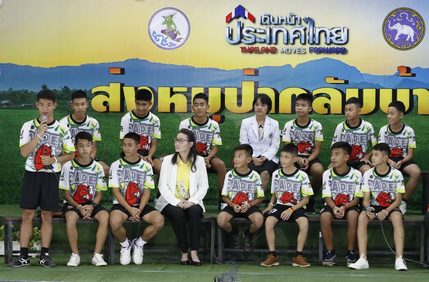 FILE - In this file photo dated Wednesday, July 18, 2018, Coach&amp;quot; Ake&amp;quot; Ekkapol Janthawong, left, speaks on behalf of the 12 boys and himself about their rescue from a flooded cave during a press conference discussing their ordeal in Chiang Rai, northern Thailand.  The British divers who helped rescue young soccer players trapped in a flooded cave in Thailand are among those being recognized in Britain’s New Year’s Honors List, according to the list of recipients released Friday Dec. 28, 2018. (AP Photo/Vincent Thian, FILE)