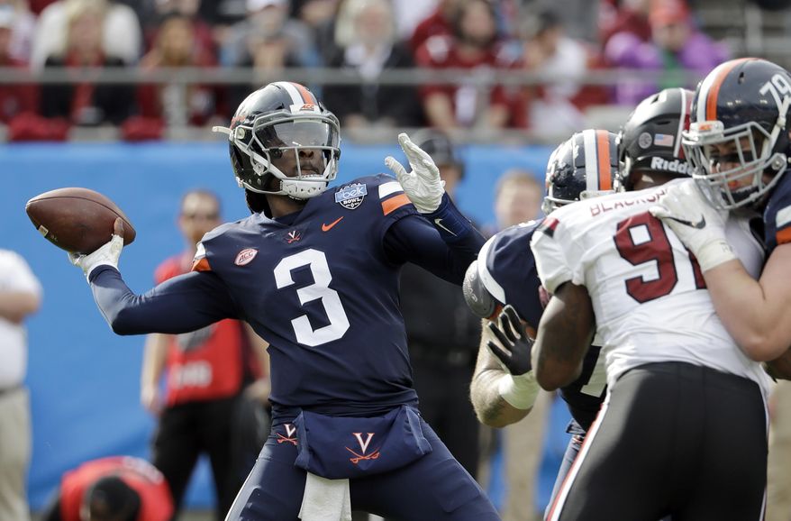 Virginia's Bryce Perkins (3) looks to pass against South Carolina during the first half of the Belk Bowl NCAA college football game in Charlotte, N.C., Saturday, Dec. 29, 2018. (AP Photo/Chuck Burton) ** FILE **