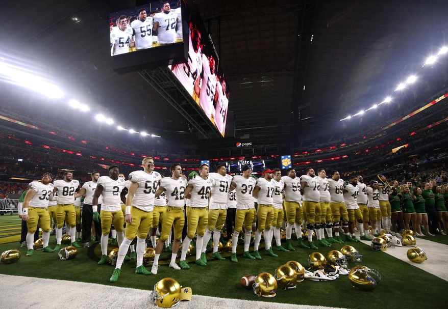 Notre Dame players stand in the end zone singing in the direction of their fans after their 30-3 loss to Clemson in the NCAA Cotton Bowl semi-final playoff football game, Saturday, Dec. 29, 2018, in Arlington, Texas. Clemson won 30-3. (AP Photo/Michael Ainsworth)