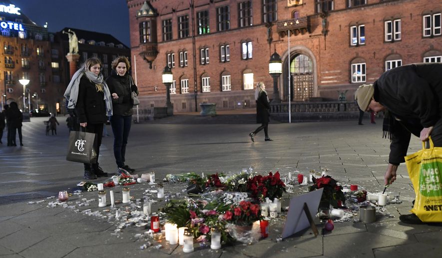 Tributes are placed in memory of two Scandinavian university students who were killed in a remote area of the Atlas Mountains in Morocco, at the Town Hall Square in Copenhagen, Friday Dec. 28, 2018. Norwegian Maren Ueland and Dane Louisa Vesterager Jespersen, were killed near Imlil in Morocco during a trekking trip. (Thomas Sjoerup / Ritzau Scanpix)