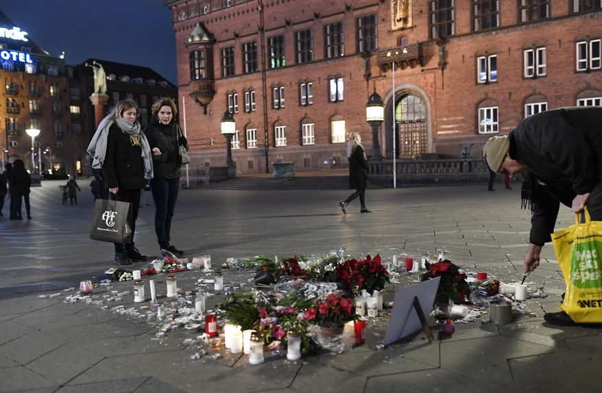 Tributes are placed in memory of two Scandinavian university students who were killed in a remote area of the Atlas Mountains in Morocco, at the Town Hall Square in Copenhagen, Friday Dec. 28, 2018. Norwegian Maren Ueland and Dane Louisa Vesterager Jespersen, were killed near Imlil in Morocco during a trekking trip. (Thomas Sjoerup / Ritzau Scanpix)
