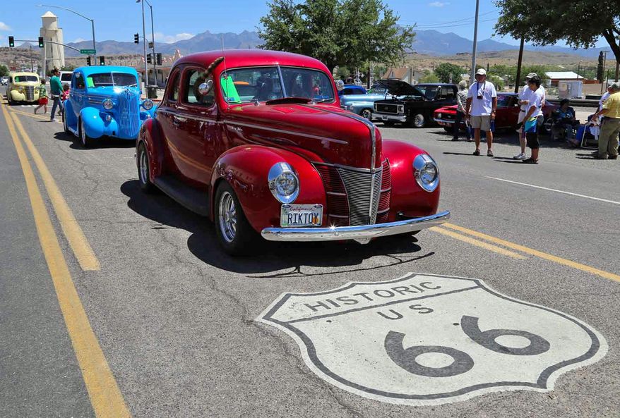 FILE - This 2017 file photo shows the annual Route 66 Fun Run, featuring vintage autos from all eras, on a street in Kingman, Ariz. Illinois lawmakers completed the state's 100th General Assembly in its bicentennial year, and will ring in 2019 with 253 new laws on the books. Also, Route 66, the storied "Mother Road" that connected Chicago to Santa Monica, Calif., in one of the nation's earliest interstate highways, turns 100 in 2026. A commission to celebrate its centennial begins work. (Kingman Daily Minor via AP)