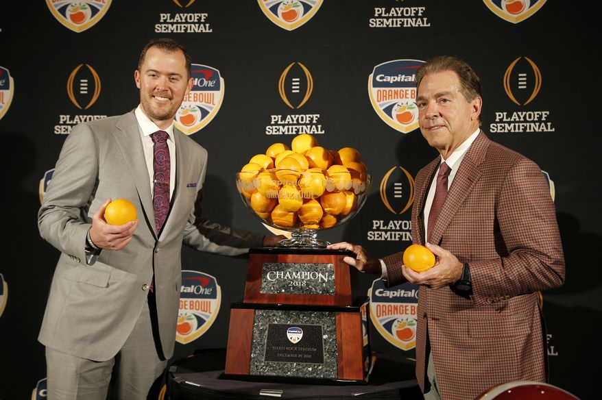 Alabama head coach Nick Saban, right, stands with Oklahoma head coach Lincoln Riley at an NCAA college football news conference in Fort Lauderdale, Fla., Friday, Dec. 28, 2018. Alabama plays Oklahoma in the Orange Bowl on Saturday, Dec. 29. (AP Photo/Joe Skipper)