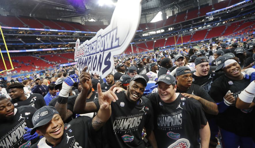Florida players celebrate after the Peach Bowl NCAA college football game against Michigan, Saturday, Dec. 29, 2018, in Atlanta. Florida won 41-15. (AP Photo/John Bazemore)