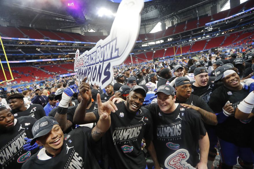 Florida players celebrate after the Peach Bowl NCAA college football game against Michigan, Saturday, Dec. 29, 2018, in Atlanta. Florida won 41-15. (AP Photo/John Bazemore)