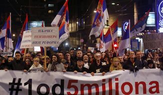 People hold a banner that reads: &#39;&#39;#1out of 5 million&#39;&#39; during a protest against populist President Aleksandar Vucic in Belgrade, Serbia, Saturday, Dec. 29, 2018. Similar protests have been held for the past three weekends to express discontent with Vucic&#39;s rule. (AP Photo/Darko Vojinovic)