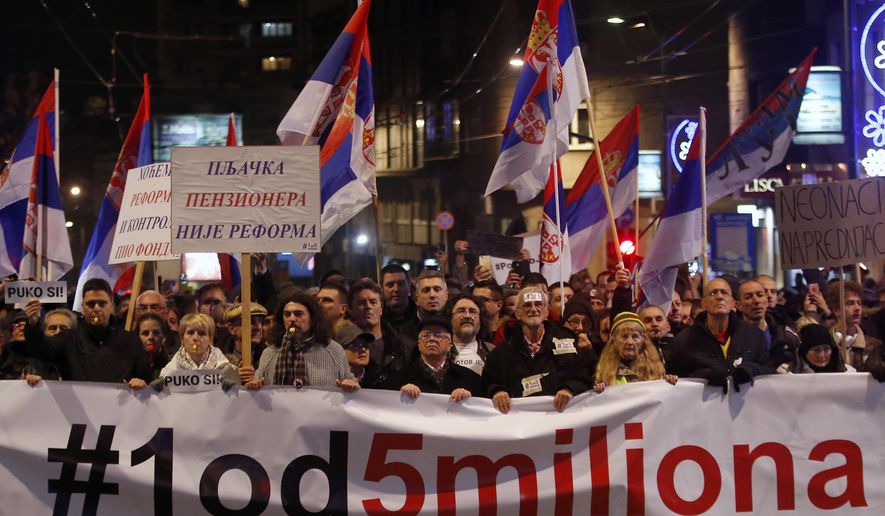 People hold a banner that reads: &#x27;&#x27;#1out of 5 million&#x27;&#x27; during a protest against populist President Aleksandar Vucic in Belgrade, Serbia, Saturday, Dec. 29, 2018. Similar protests have been held for the past three weekends to express discontent with Vucic&#x27;s rule. (AP Photo/Darko Vojinovic)