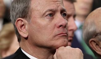 In this Tuesday, Jan. 30, 2018, file photo, U.S. Supreme Court Chief Justice John Roberts listens as President Donald Trump delivers his first State of the Union address in the House chamber of the U.S. Capitol to a joint session of Congress Tuesday in Washington. (Win McNamee/Pool via AP) ** FILE **