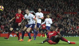 Manchester United&#39;s Paul Pogba, foreground, scores his side&#39;s first goal of the game against Bournemouth, during their English Premier League soccer match at Old Trafford in Manchester, England, Sunday Dec. 30, 2018. (Martin Rickett/PA via AP)