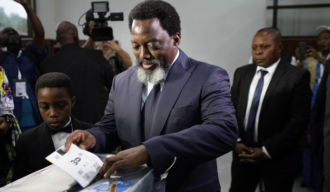 Congolese President Joseph Kabila casts his vote Sunday, Dec. 30, 2018 in Kinshasa, Congo. Forty million voters are registered for a presidential race plagued by years of delay and persistent rumors of lack of preparation. (AP Photo/Jerome Delay)
