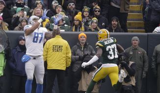 CORRECTS TO REMOVE SCORE- Detroit Lions&#x27; Levine Toilolo catches a touchdown pass on a fake field goal in front of Green Bay Packers&#x27; Josh Jackson during the first half of an NFL football game Sunday, Dec. 30, 2018, in Green Bay, Wis. (AP Photo/Mike Roemer)